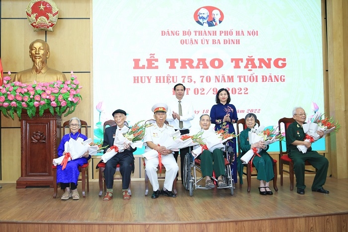 Phó Bí thư Thường trực Thành ủy Nguyễn Thị Tuyến trao Huy hiệu Đảng và tặng hoa chúc mừng các đảng viên