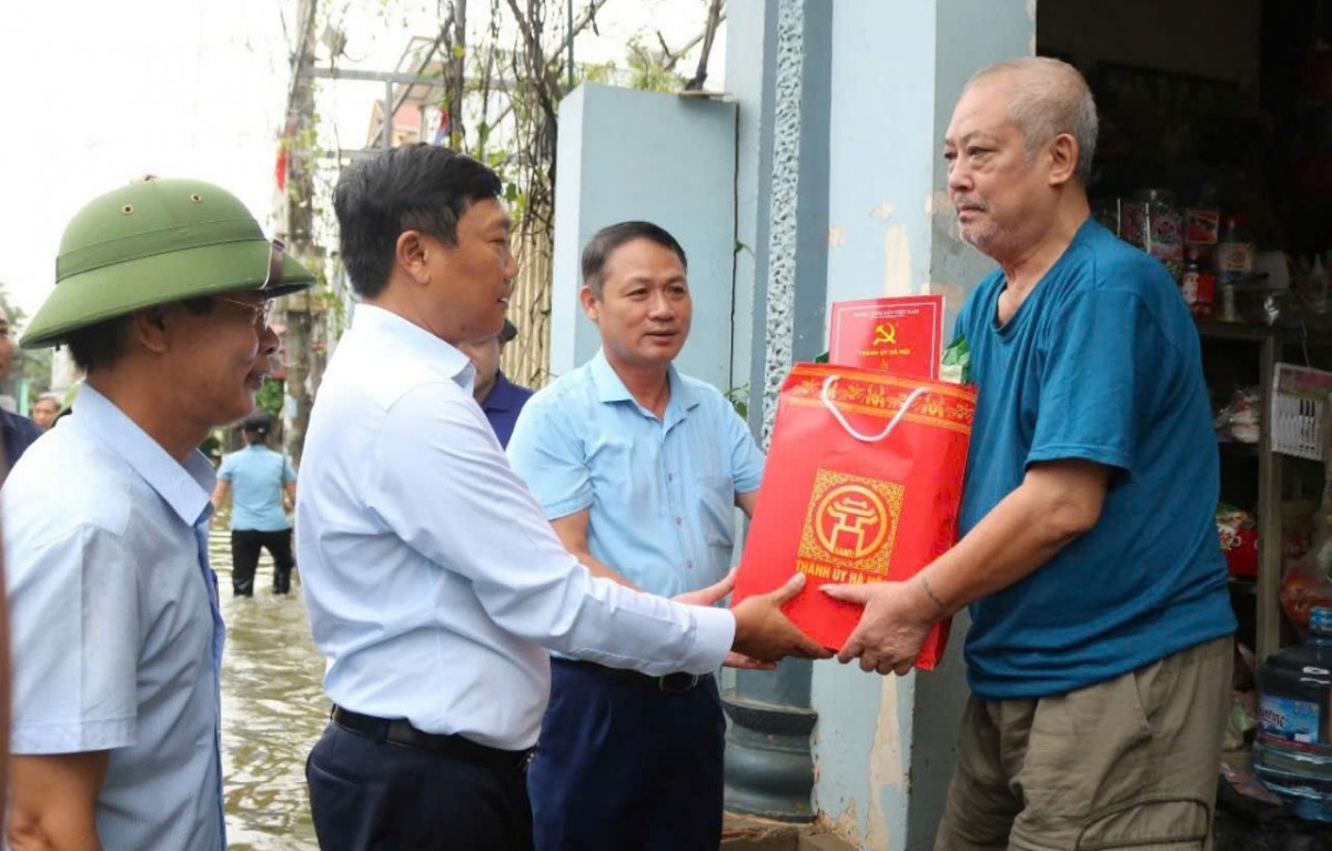 Lãnh đạo thành phố và huyện Quốc Oai tặng quà động viên các hộ dân trong xóm Bến Vôi.