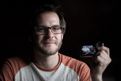 In this photograph taken on May 3, 2015, US trekker Corey Ascolani, 34, holds the camera he used record a video of the earthquake during an interview in Kathmandu. Ascolani was among hundreds of tourists travelling in the scenic Langtang region when a 7.8-magnitude earthquake on April 25 flattened villages and unleashed avalanches in Nepal's Himalayas, killing more than 7,300 people. AFP PHOTO/Philippe Lopez